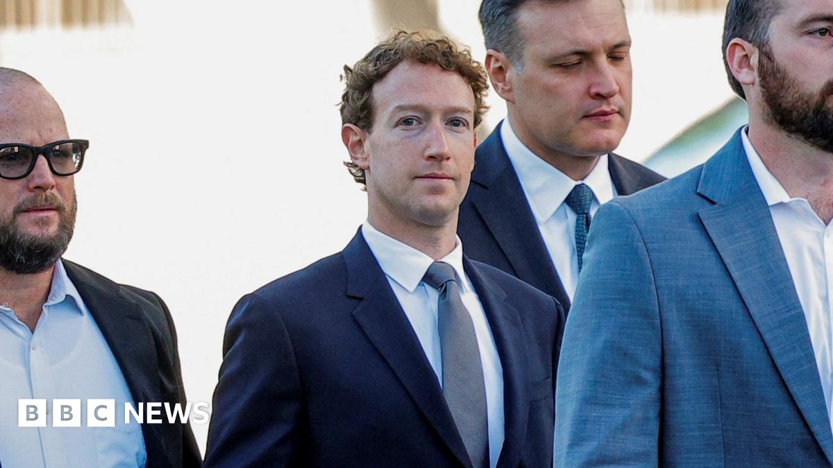Adam Mosseri, head of Instagram, speaking before a Senate committee in 2021 wearing rounded black-rimmed eyeglasses and a simple dark blue suit and tie.