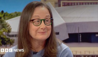 Julie Maughan, a woman with brown hair and glasses