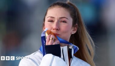Mikaela Shiffrin crouches on skis after winning Olympic gold in slalom in Cortina
