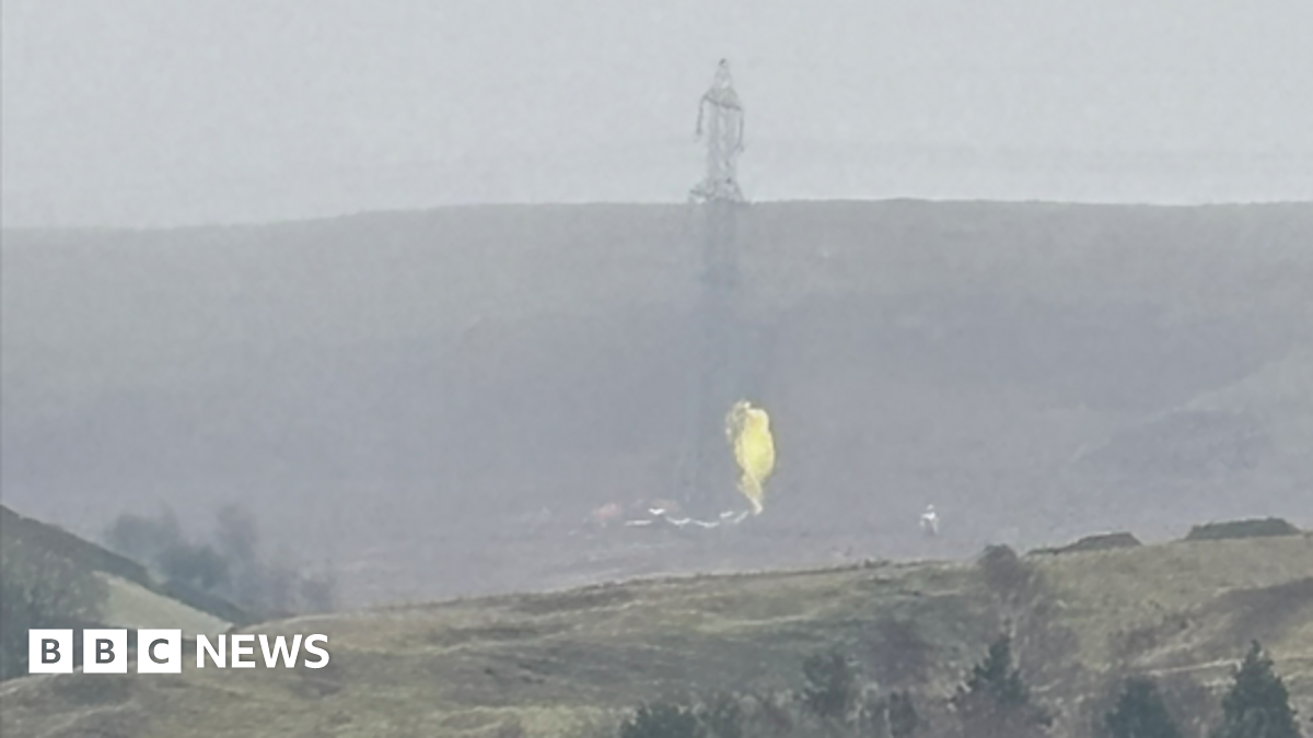 An image being shared on social media later showed what appeared to be a parachute caught on a nearby pylon, showing a yellow material in misty conditions