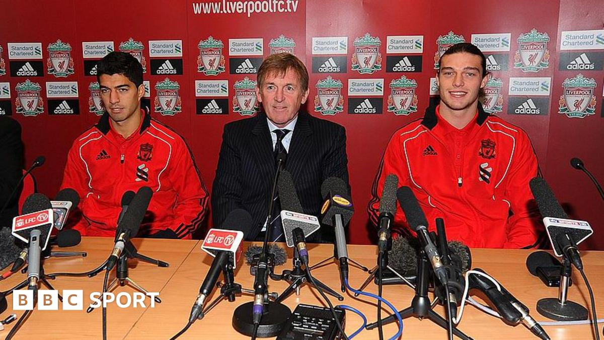 Andy Carroll and Luis Suarez of Liverpool attend a press conference with manager Kenny Dalglish at Anfield on February 3, 2011