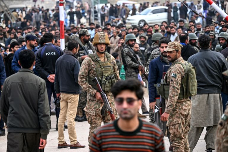 Security personnel stand guard outside a mosque following an explosion, in Islamabad on February 6, 2026. A blast at a Shiite mosque in Pakistan's capital Islamabad on February 6 killed 15 people and wounded at least 80, local authorities said. (Photo by Farooq NAEEM / AFP)