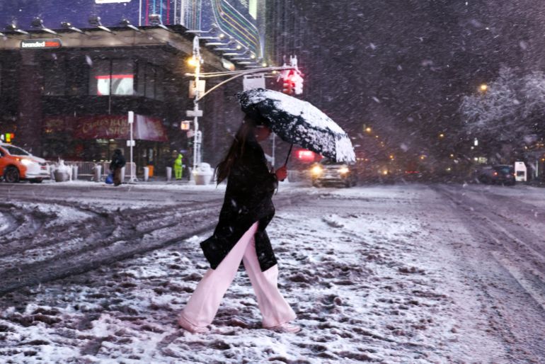 A woman crosses Manhattan's 8th Avenue