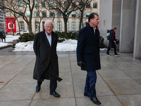 Frank Stronach, left, arrives at the 361 University Ave. courthouse in Toronto, on Tuesday, February 17, 2026.