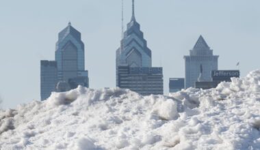 Snow and ice debris is piled along the Camden waterfront in Camden, N.J., framing the Philadelphia skyline across the Delaware River, Thursday, Feb. 5, 2026.