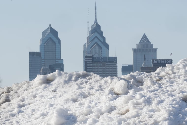 Snow and ice debris is piled along the Camden waterfront in Camden, N.J., framing the Philadelphia skyline across the Delaware River, Thursday, Feb. 5, 2026.