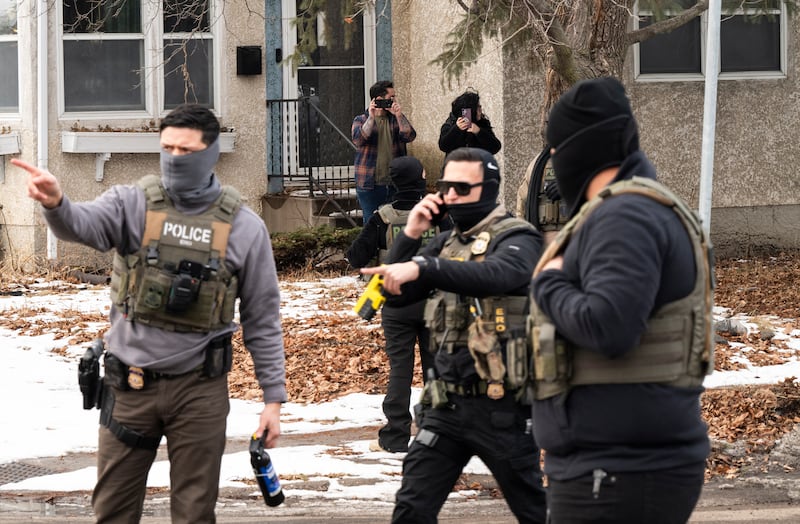 Observers film ICE agents as they hold a perimeter after one of their vehicles got a flat tire on Penn Avenue on February 5, 2026 in Minneapolis, Minnesota. Protests continue calling for an end to immigration raids in the Twin cities which have already resulted in the fatal shooting deaths of Alex Pretti, a VA nurse, and Renee Good, a mother of three, by federal agents.