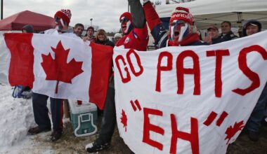 New England Patriots fans waving a Canada flag before an NFL game.