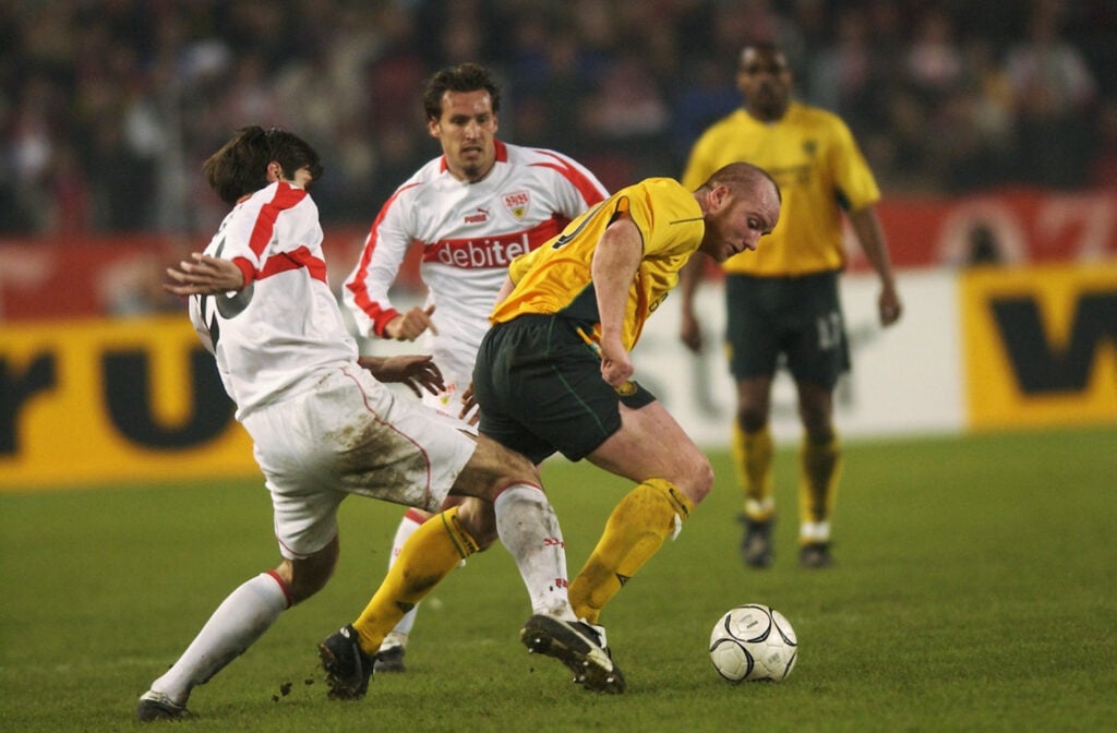 John Hartson of Celtic holds the ball up against Michael Mutzel of VFB Stuttgart during the UEFA Cup fourth round