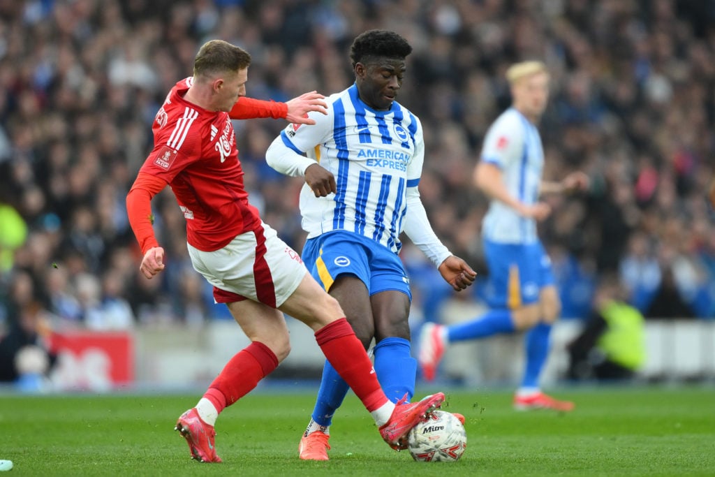 Carlos Baleba and Elliott Anderson battle for the ball during Brighton vs Nottingham Forest.