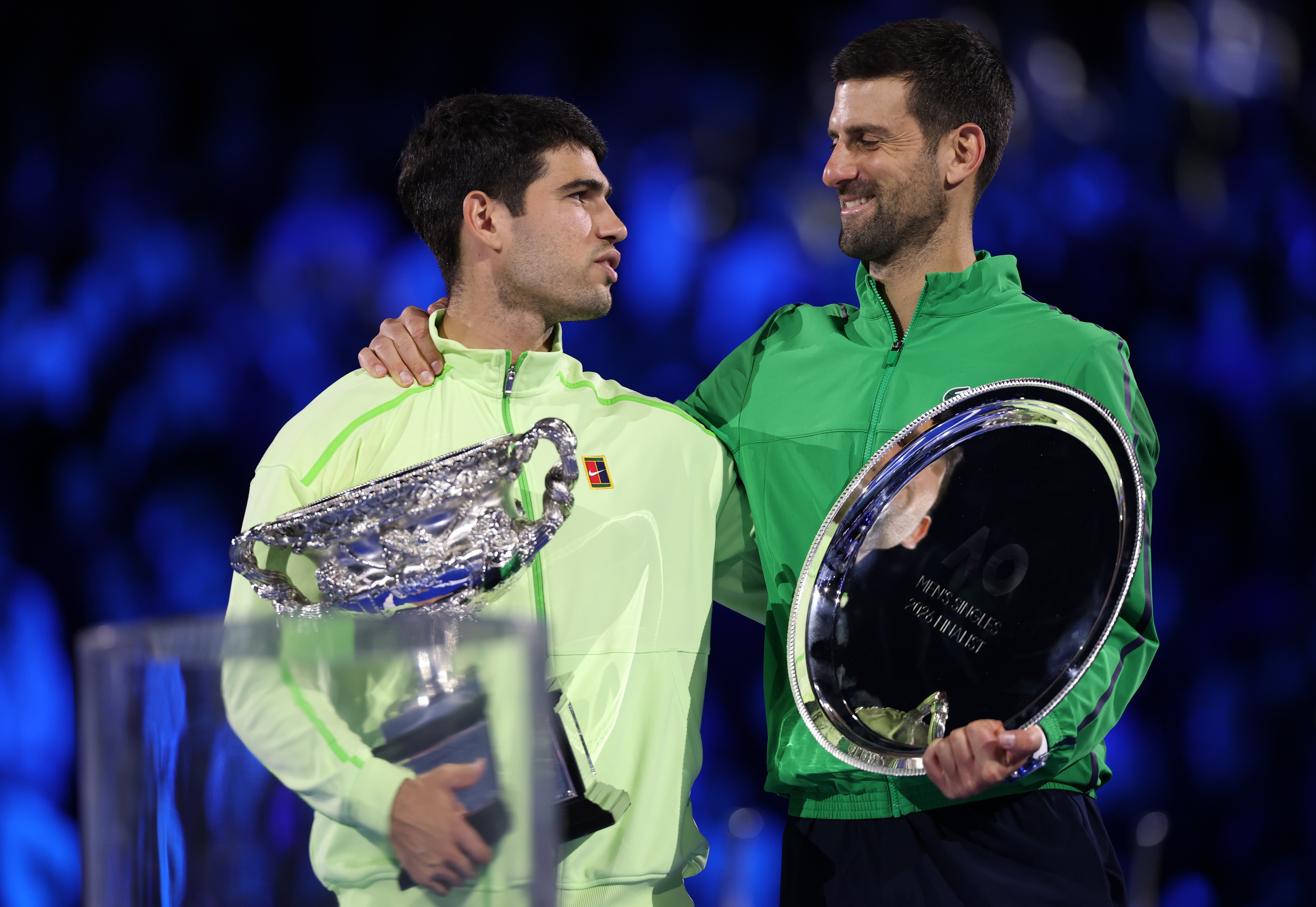 Carlos Alcaraz celebrates with the Australian Open trophy after completing the career grand slam