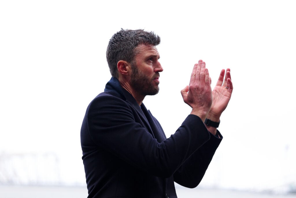 Michael Carrick applauds after the Premier League match between Manchester United and Tottenham Hotspur at Old Trafford in 2026 in Manchester, England.