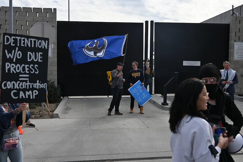 OTAY MESA, CALIFORNIA - FEBRUARY 12: People protest outside the Otay Mesa Port of Entry near the US-Mexico Border while U.S. Secretary of Homeland Security Kristi Noem holds a press conference on February 12, 2026 in Otay Mesa, California. Noem provided an update on border security and drug seizures while taking questions from the media. (Photo by Carlos A. Moreno/Getty Images)