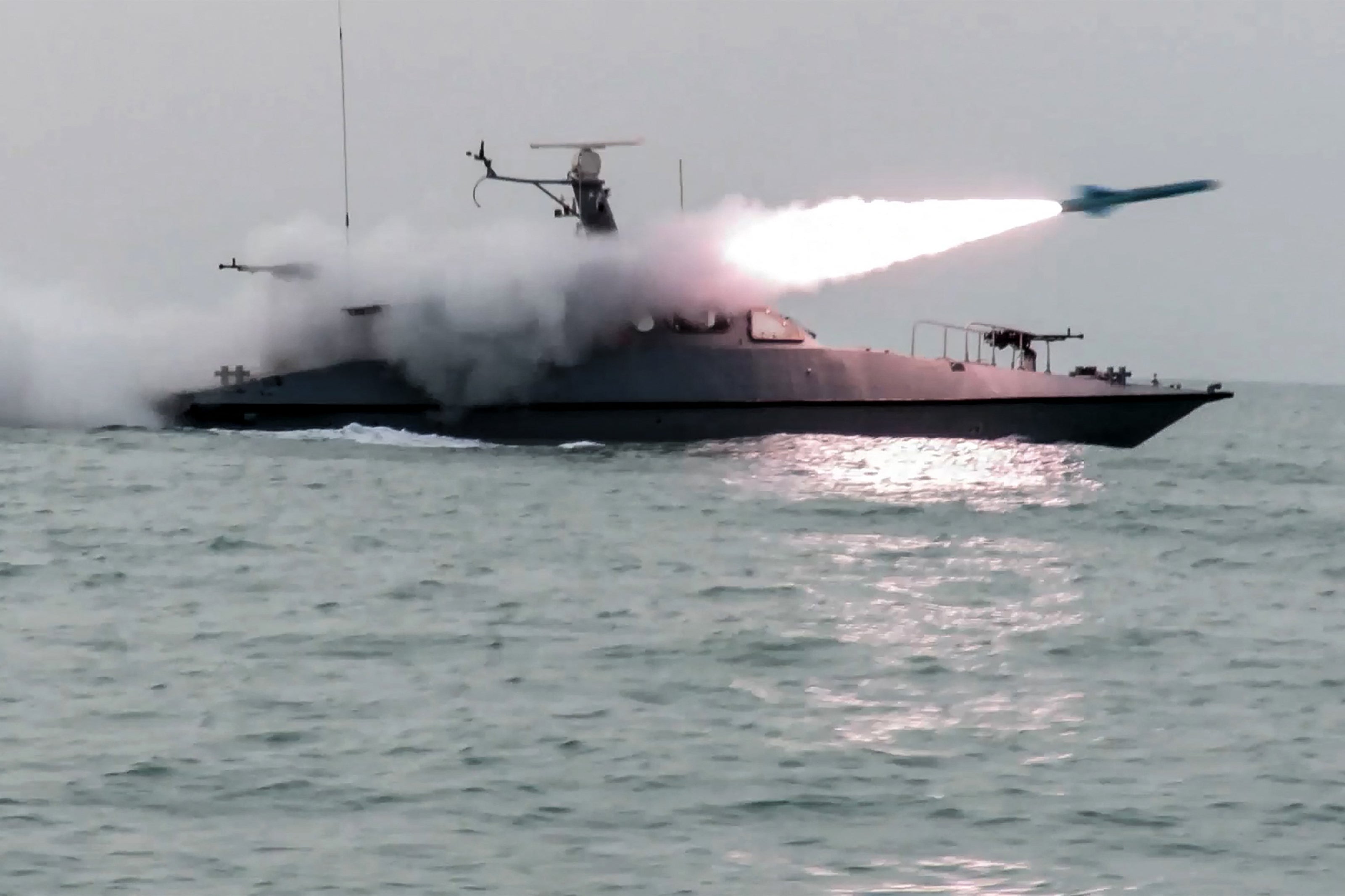 A boat firing a missile during a military exercise by members of the IRGC and navy in the Gulf