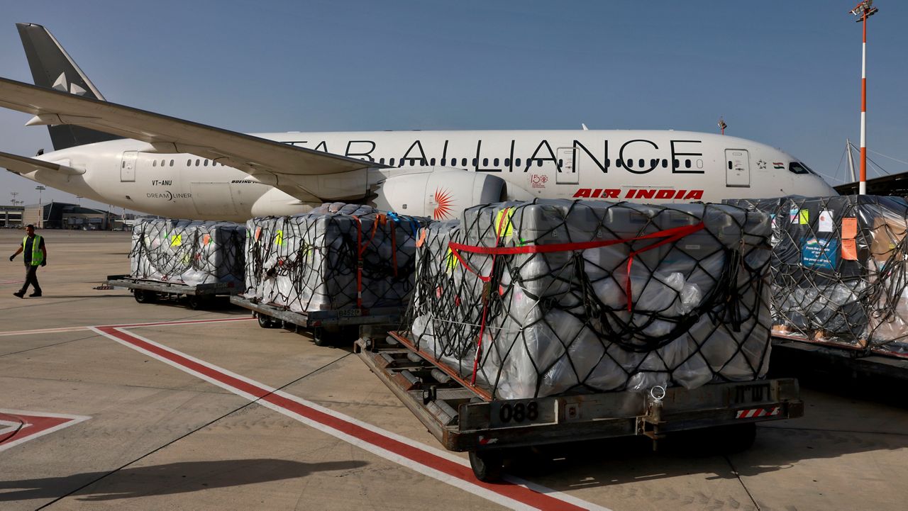 Workers load medical aid onto an Air India plane to be flown to India, at Ben Gurion Airport near Tel Aviv, Israel, May 4, 2021. (Menahem Kahana/Pool Photo via AP, File)