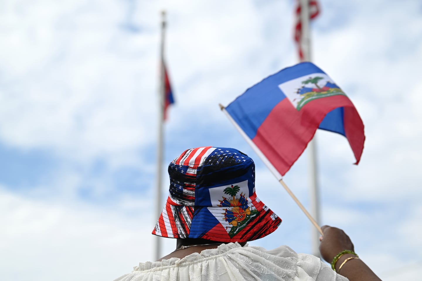 Margarette Woods of Somerville, waved a Haitian flag while wearing a hat with both US and Haitian colors at a Haitian flag festival at Somerville City Hall last year.