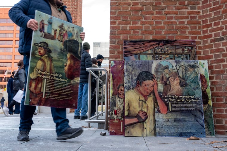 Workers remove display panels about slavery at the President’s House site in Independence National Historical Park Jan. 22, 2026.  A federal judge ordered the panels restored Monday.