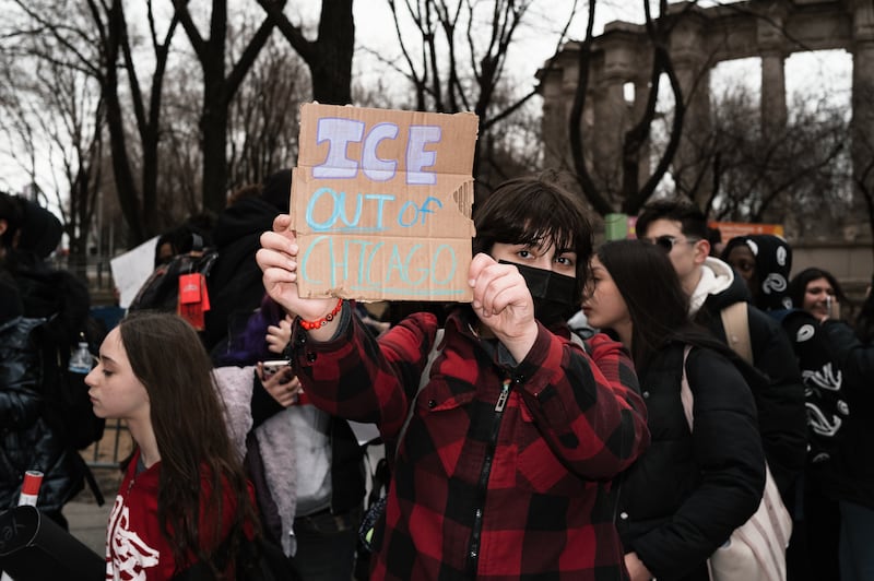 A demonstrator holds a placard reading ''ice out of chicago'' during a protest