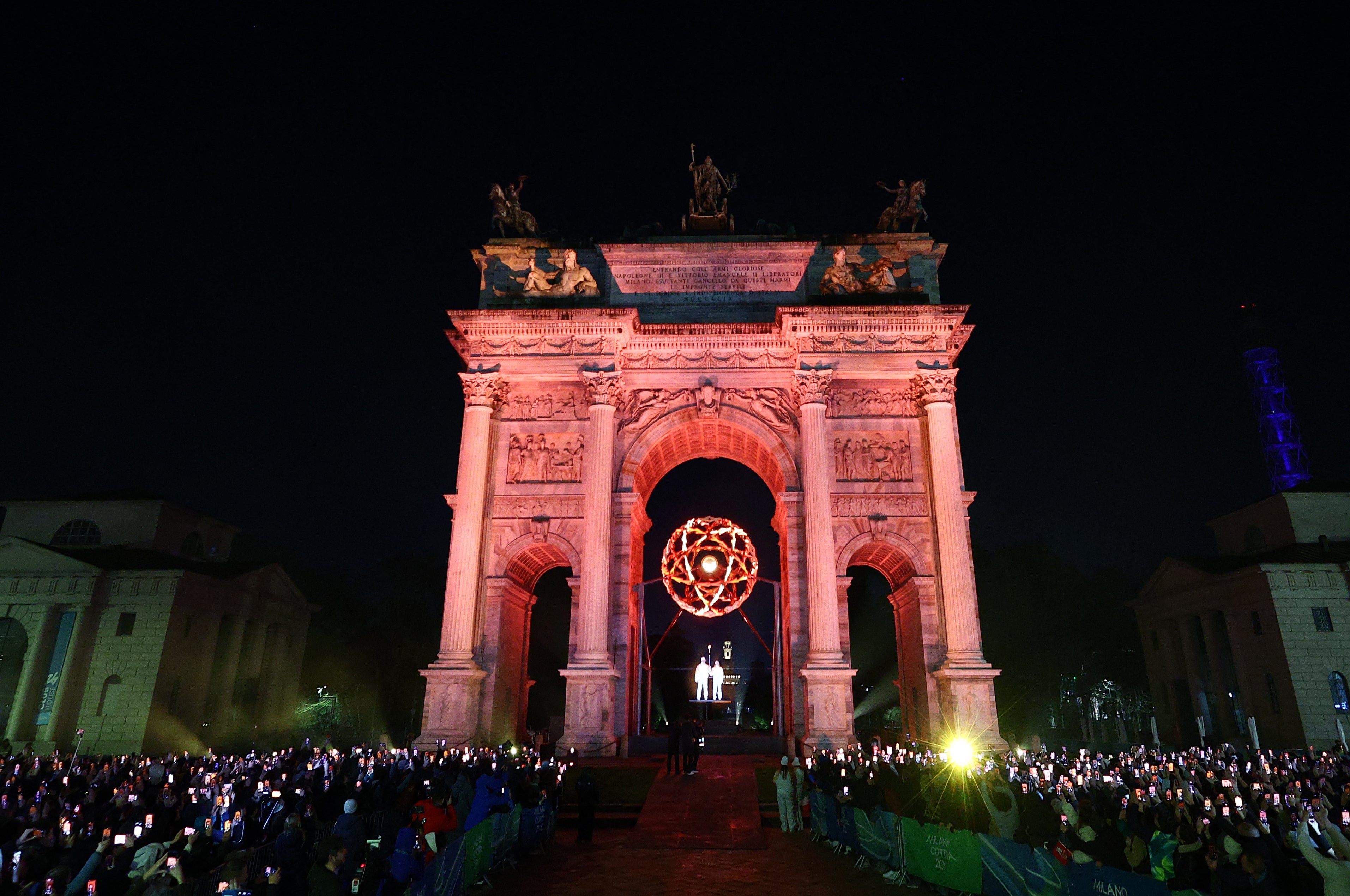 The Olympic cauldron under the Arco della Pace in Milan is lit by Alberto Tomba and Deborah Compagnoni