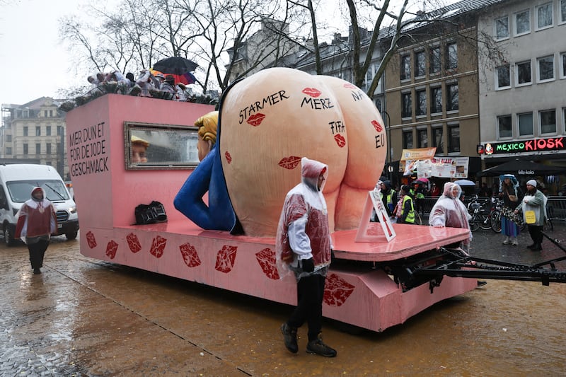 16 February 2026, North Rhine-Westphalia, Cologne: A float showing US President Trump with a bare bottom takes part in the Rose Monday parade in Cologne. Rose Monday on the Rhine is the highlight of the Rhineland carnival season with its traditional parades. Photo: Oliver Berg/dpa (Photo by Oliver Berg/picture alliance via Getty Images)