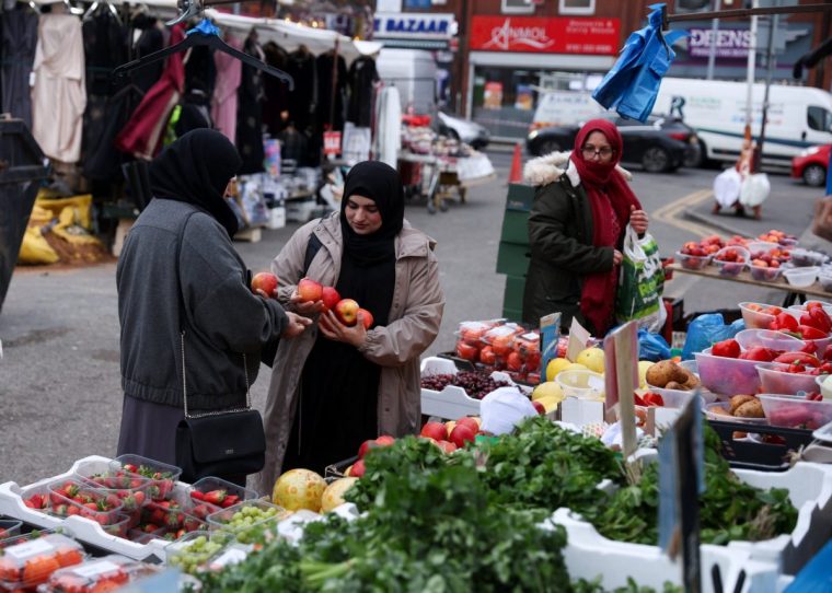 People shop for fruits at Longsight market, as the northwest region of Gorton and Denton will be holding a by-election in February after Andrew Gywnne stepped down due to ill health, in Gorton, Britain January 30, 2026. REUTERS/Temilade Adelaja