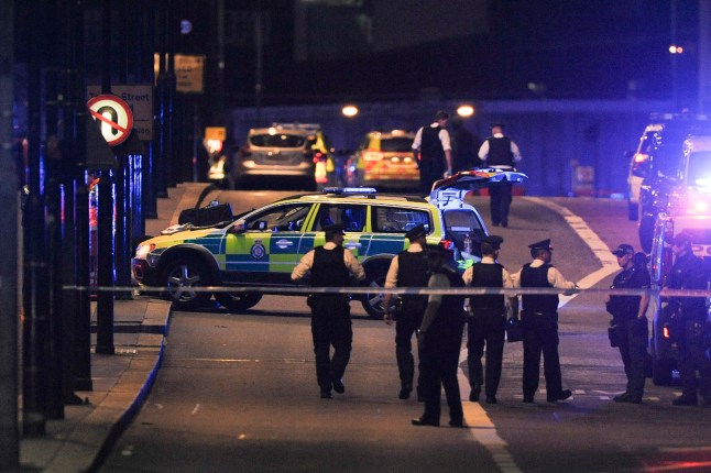 TOPSHOT - Police officers walk at the scene of an apparent terror attack on London Bridge in central London on June 3, 2017. Armed police fired shots after reports of stabbings and a van hitting pedestrians on London Bridge on Saturday in an incident reminiscent of a terror attack in March just days ahead of a general election. (Photo by DANIEL SORABJI / AFP) (Photo by DANIEL SORABJI/AFP via Getty Images)