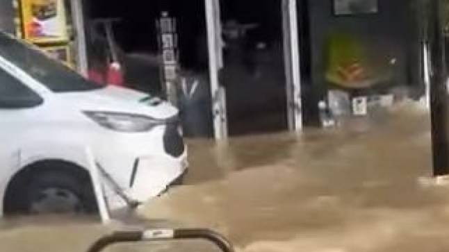 A screen grab showing brown water flooding around shops in Islington.