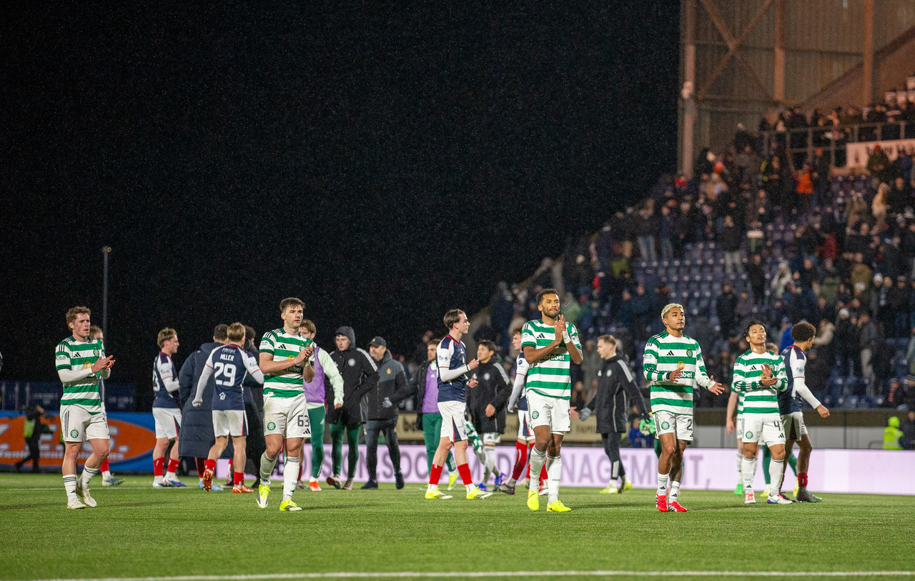 Celtic players applaud the travelling support.