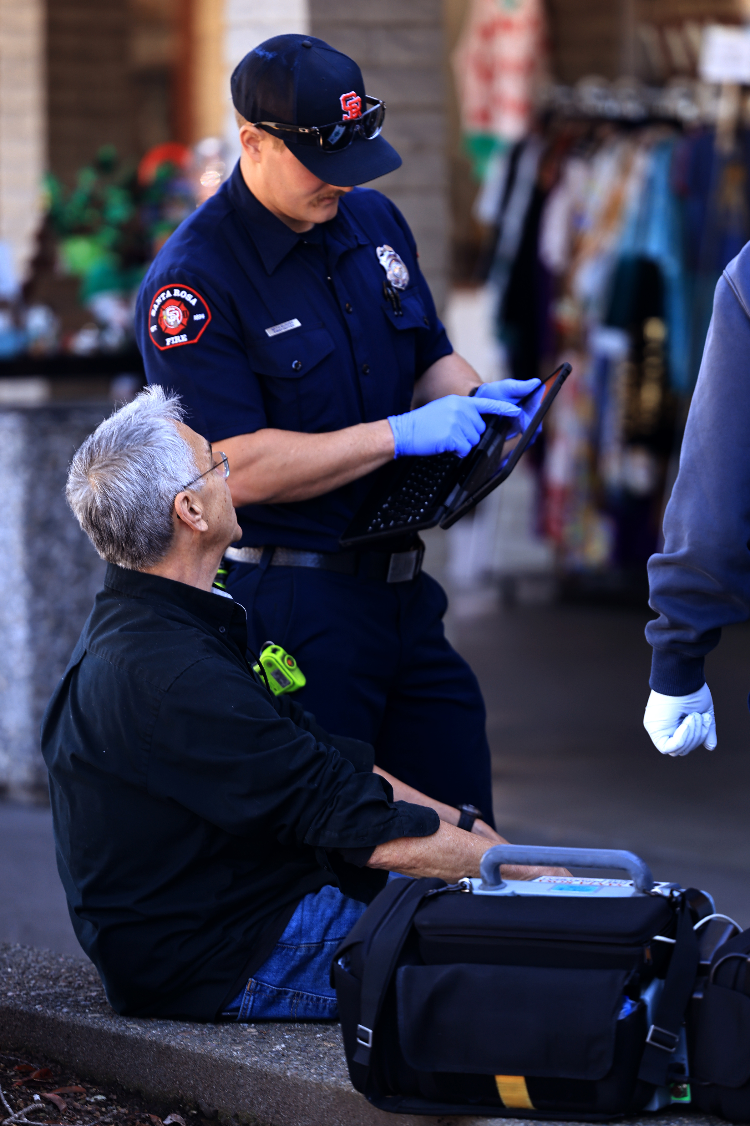 A Santa Rosa firefighter asks questions about injuries to an...