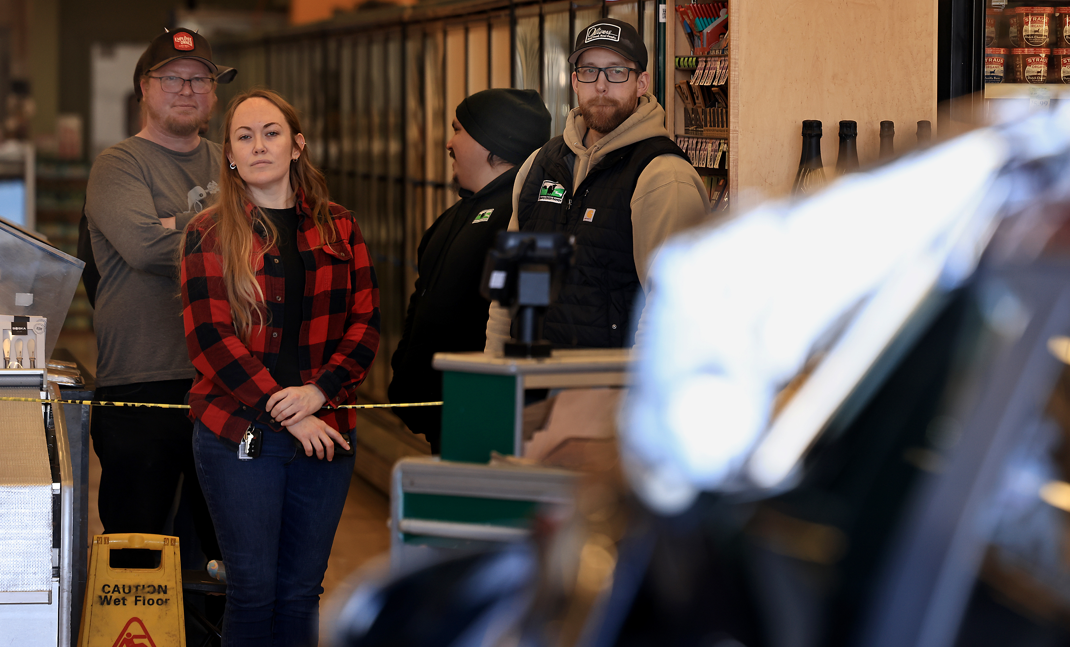 Oliverâs Market employees watch as a vehicle is pulled from...