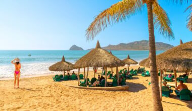 Tourists enjoy a private resort club with straw hut cabanas along the sandy Playa Gaviotas beach in the Golden Zone of Mazatlan, Mexico, along the Sinaloa Riviera.