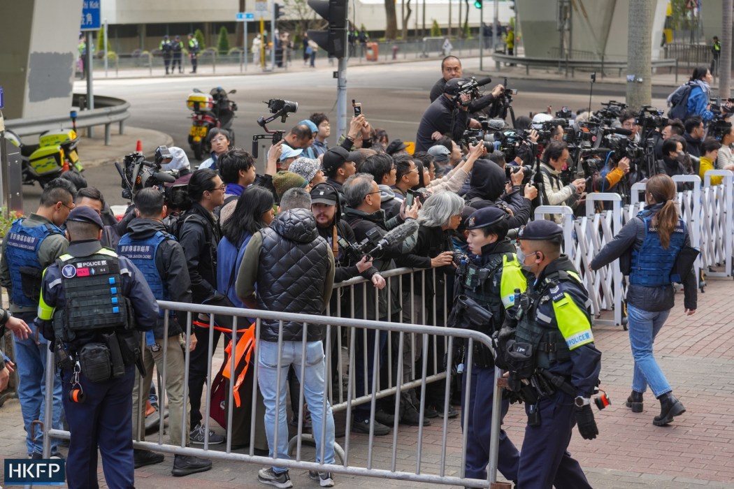 Journalists and police officers outside the West Kowloon Law Courts Building on February 9, 2026, ahead of the sentencing of pro-democracy media tycoon Jimmy Lai. Photo: Kyle Lam/HKFP.