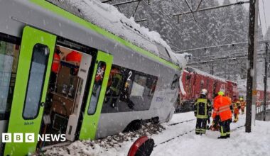 A Swiss BLS train is covered in snow following a derailment on the line linking Goppenstein to Hohtenn which injured at least five people, according to police.
