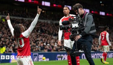 A cameraman films Arsenal's Eberechi Eze as he celebrates scoring a goal