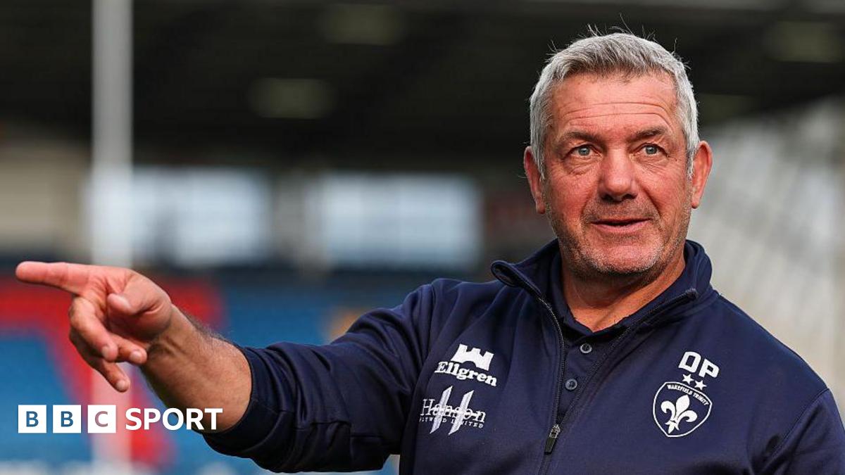 Daryl Powell directs training in a blue Wakefield Trinity top