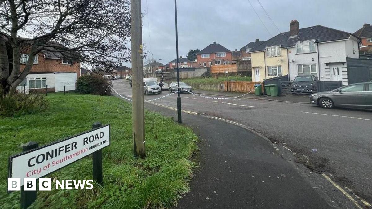 A shot of Conifer Road. Police tape can be seen blocking off access to the street.