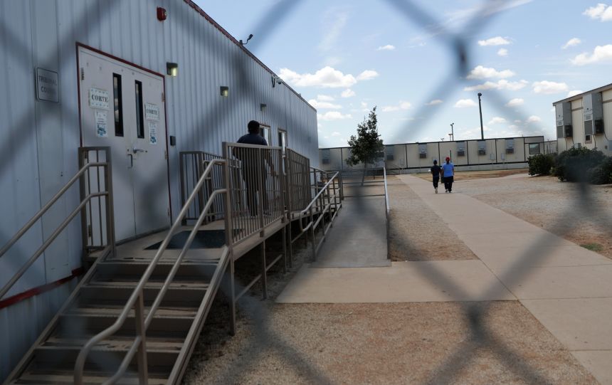 Immigrants seeking asylum walk at the South Texas Family Residential Center in Dilley, Texas, in 2019.