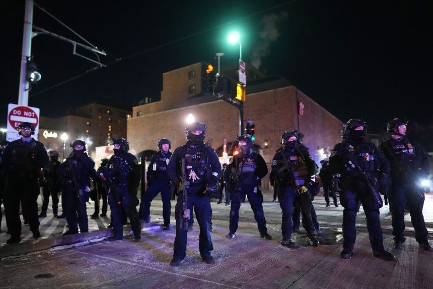 Law enforcement officers prepare to make arrests after declaring an unlawful assembly during a protest in Minneapolis on January 28.
