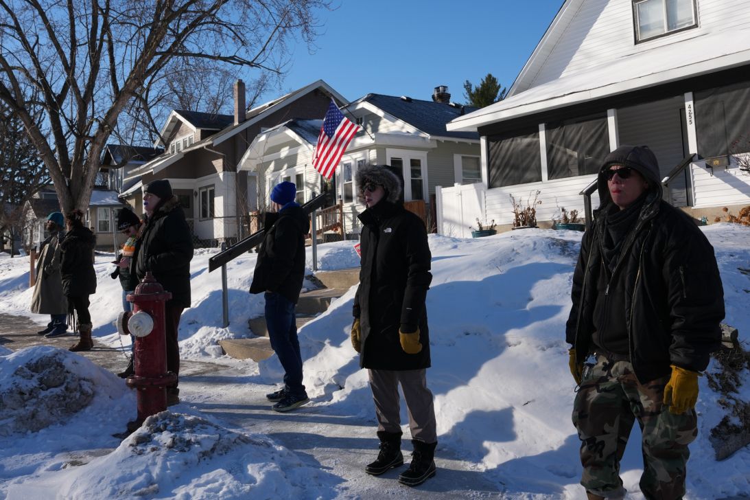 People alert the neighborhood that federal agents are in the area on January 29, 2026, in Minneapolis. (AP Photo/Adam Gray)