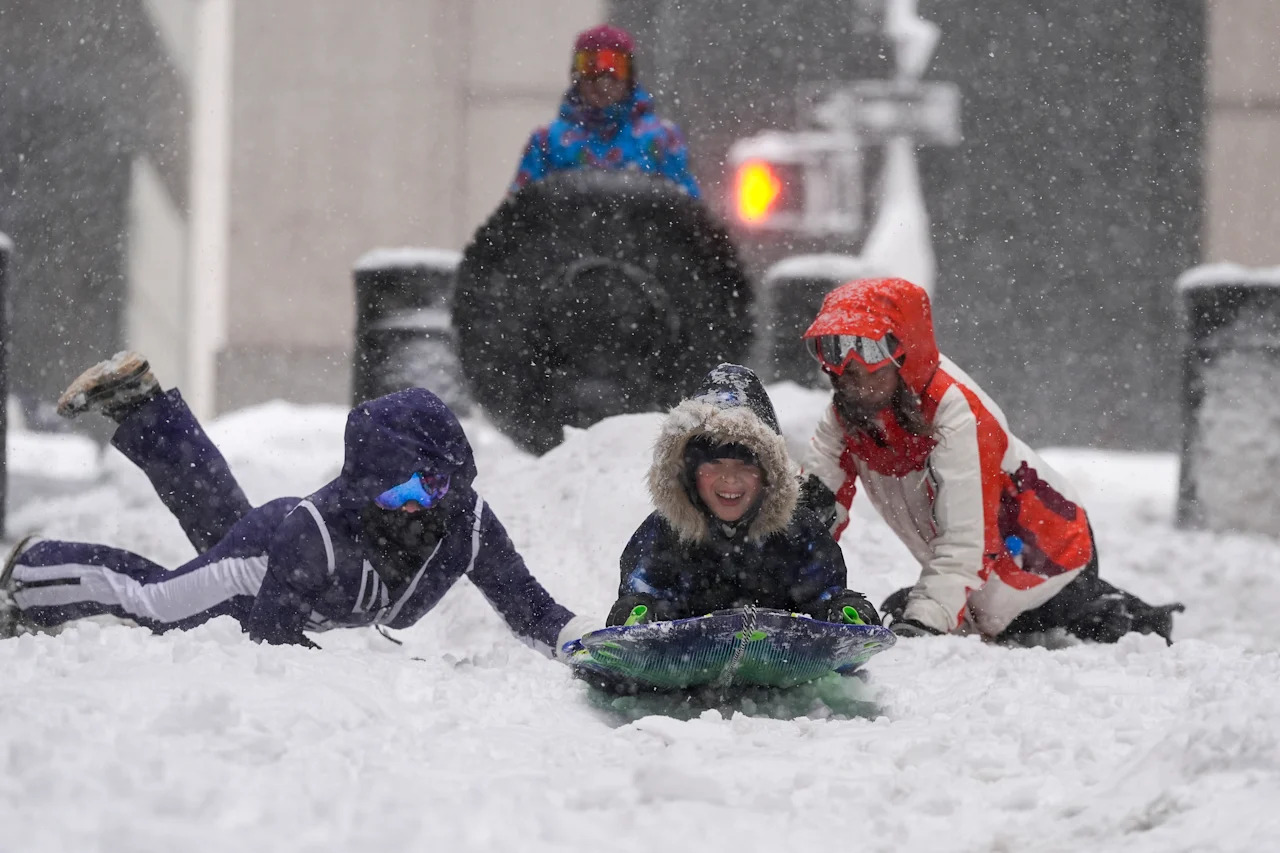 Kids sled down a street in lower Manhattan during a snowstorm on Feb. 23,  in New York. 