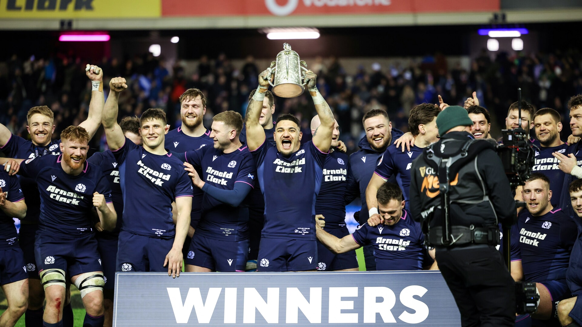 Scotland's Sione Tuipulotu lifts the Calcutta Cup at full time