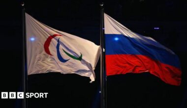 Paralympic flag and Russia flag flying side-by-side