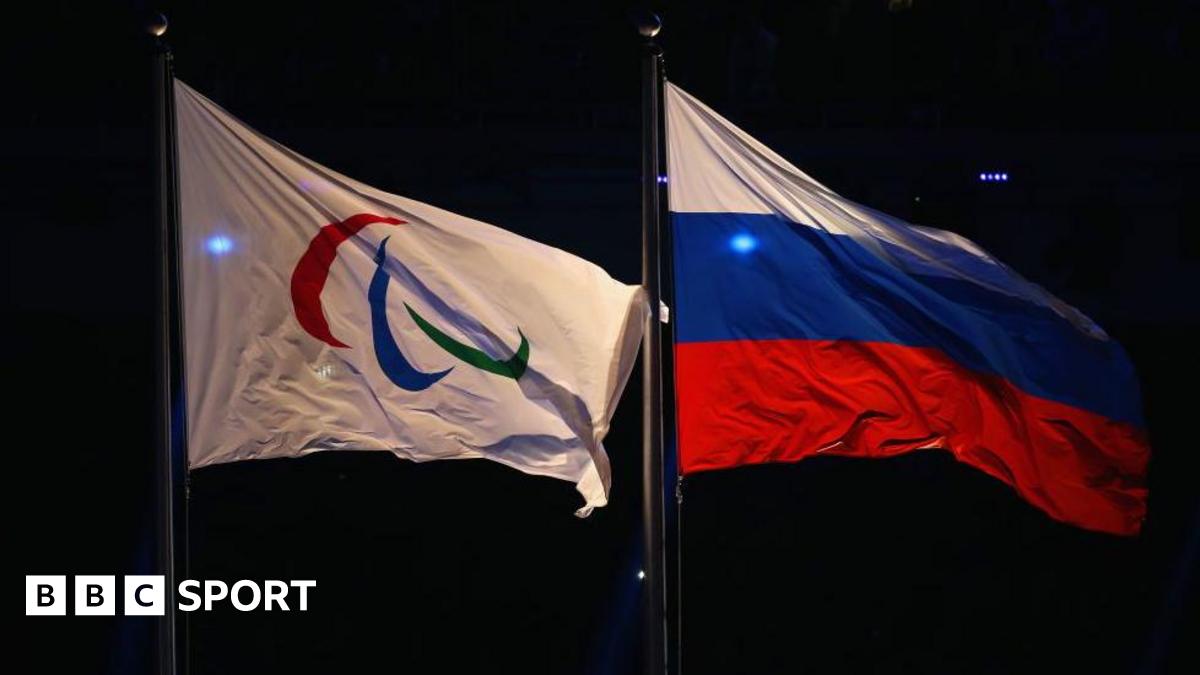 Paralympic flag and Russia flag flying side-by-side