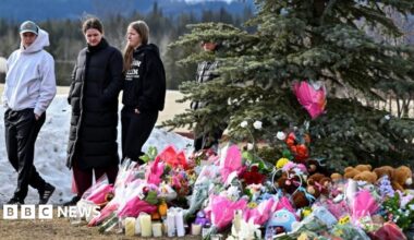 Community members mourn during a candlelight vigil for the victims of Tumbler Ridge Secondary School in Canada