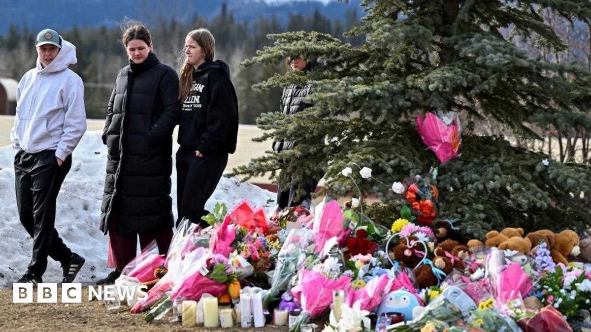Community members mourn during a candlelight vigil for the victims of Tumbler Ridge Secondary School in Canada