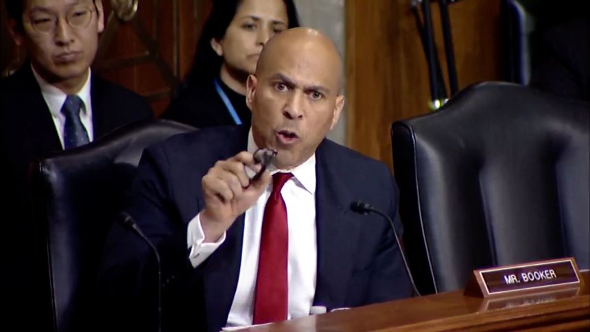 Sen. Cory Booker presses Carl about some of his previous statements.