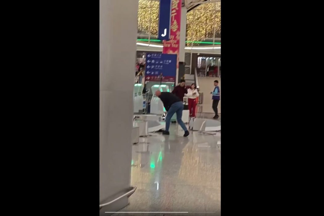 A screenshot of a video showing a man smashing a self-service check-in kiosk with a metal post at the Hong Kong International Airport on February 16, 2026. Photo: Screenshot, via Threads.