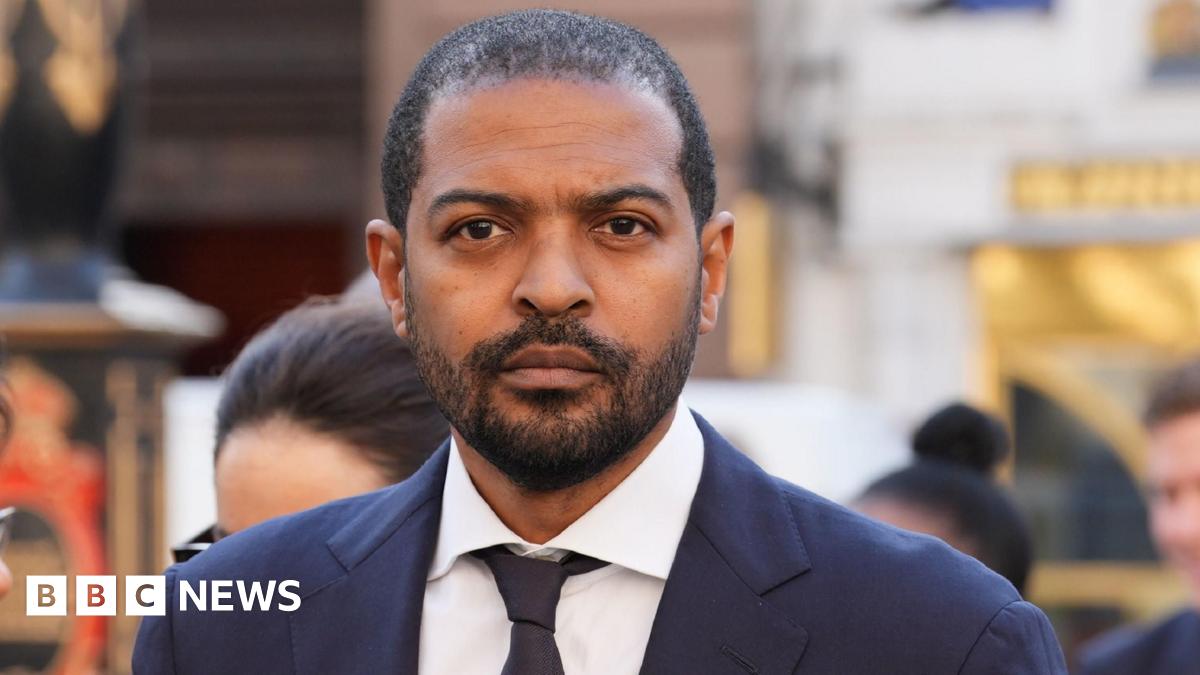 An aerial photo showing a sea of flooded fields in Somerset and in the foreground is a hill with a church on the top