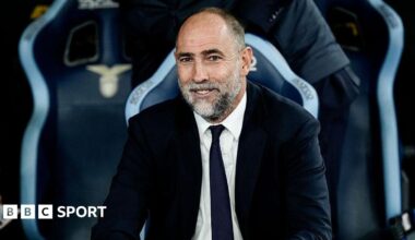 Igor Tudor smiles and is wearing a suit and tie