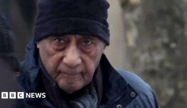 Malcolm Phillips head and shoulders image wearing a coat and hat while arriving at court in a grab from footage